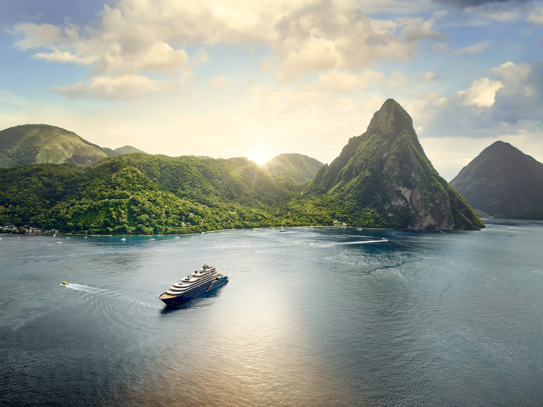 Ritz-Carlton yacht Evrima cruising past the Pitons in St. Lucia at sunset