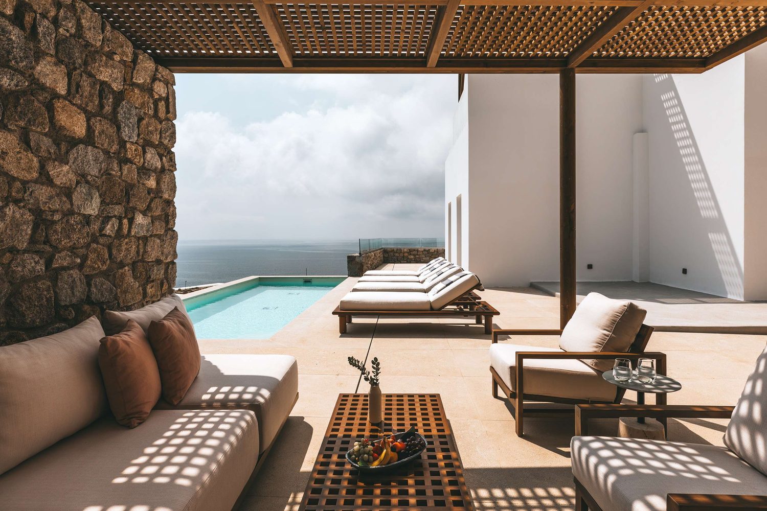 A private pool suite terrace at Cali Mykonos, its plunge pool looking out over the Aegean