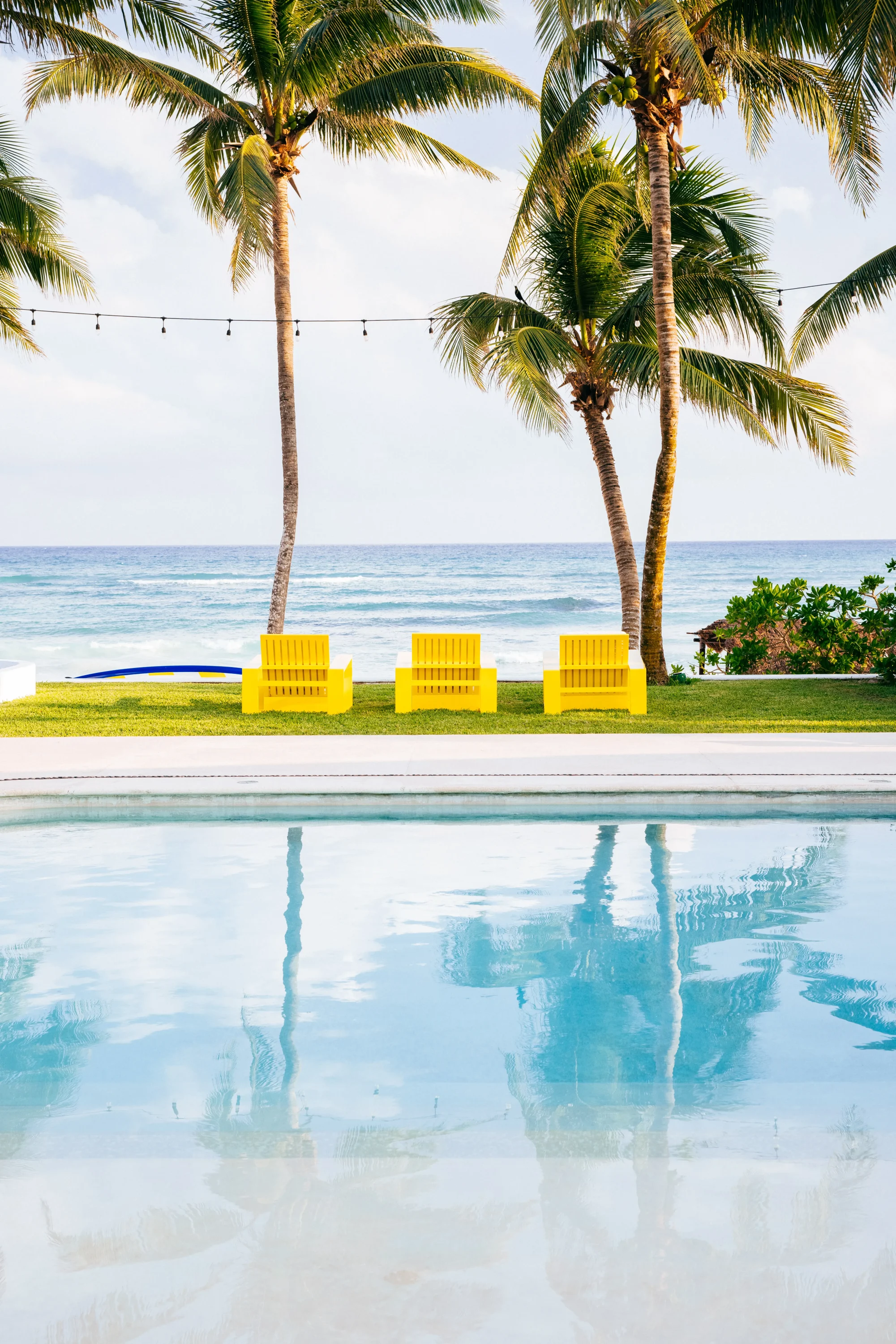 Palm-lined pool at Hotel Esencia, Riviera Maya
