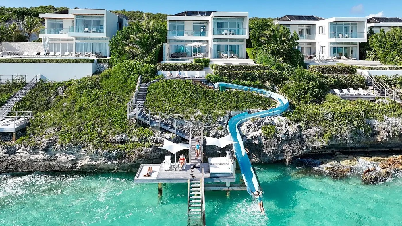 The waterslide dropping from the clifftop villas into the sea at Wymara, Turks and Caicos